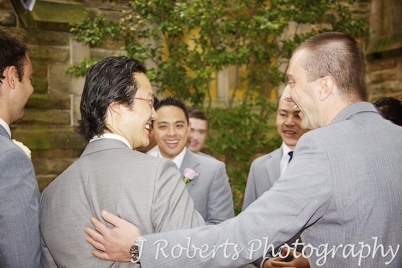 Groom being congratulated after wedding ceremony - wedding photography sydney